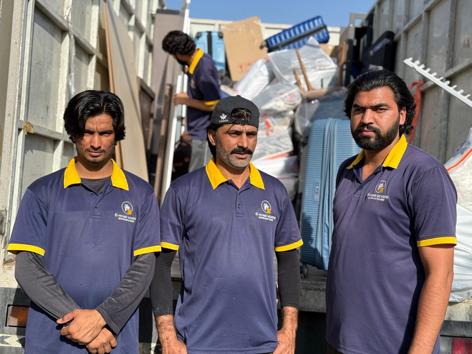 Villa moving team in Dubai loading a closed truck at a villa